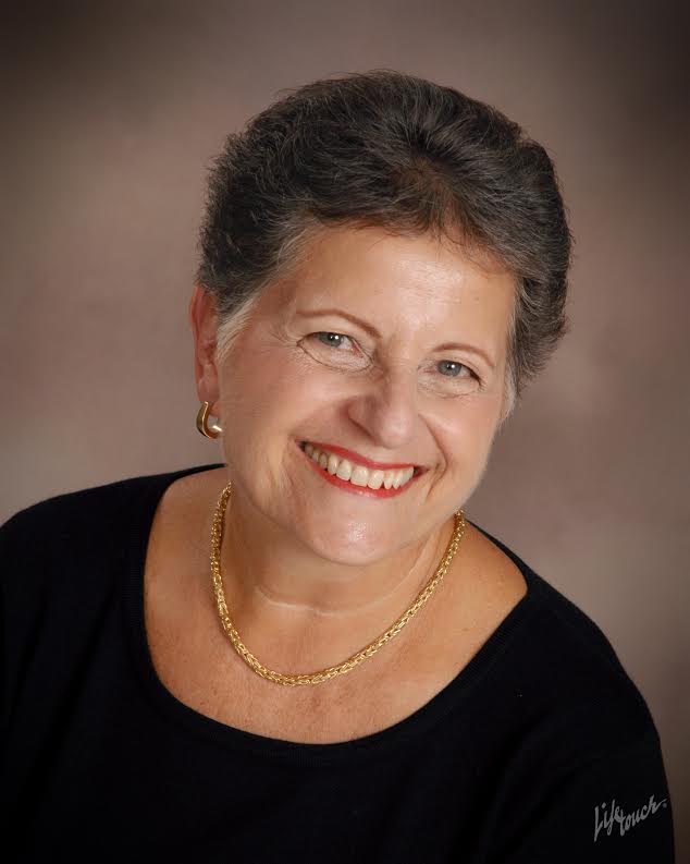 Ginny Franco smiling at the camera in this professional photo